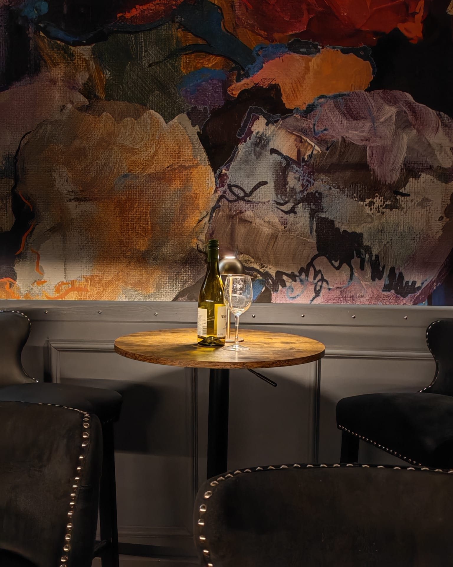 Intimate table setting beside The Aslan Lounge artwork